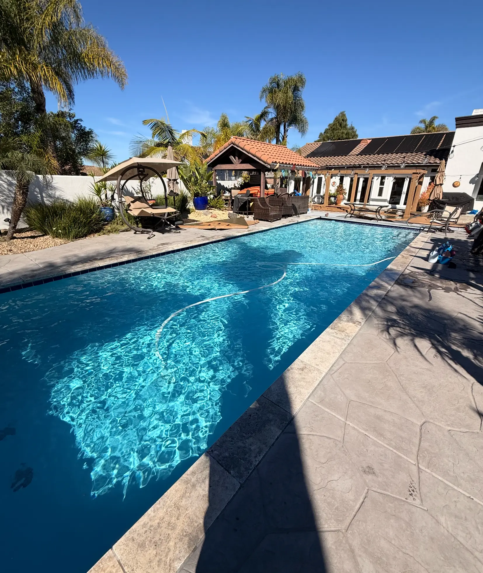 Rectangular pool with sparkling water and stamped deck